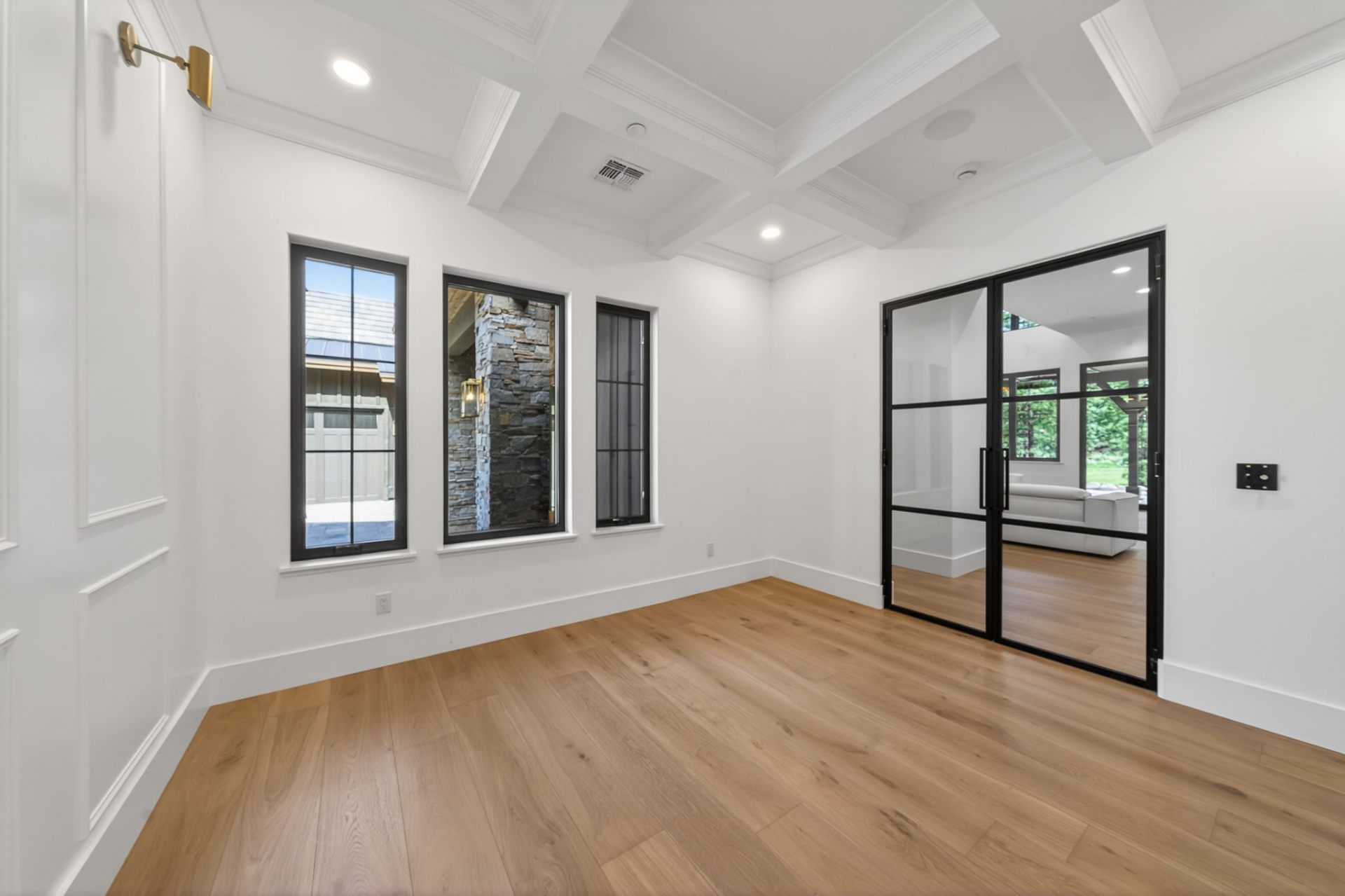 Study with coffered ceiling and steel-framed glass doors