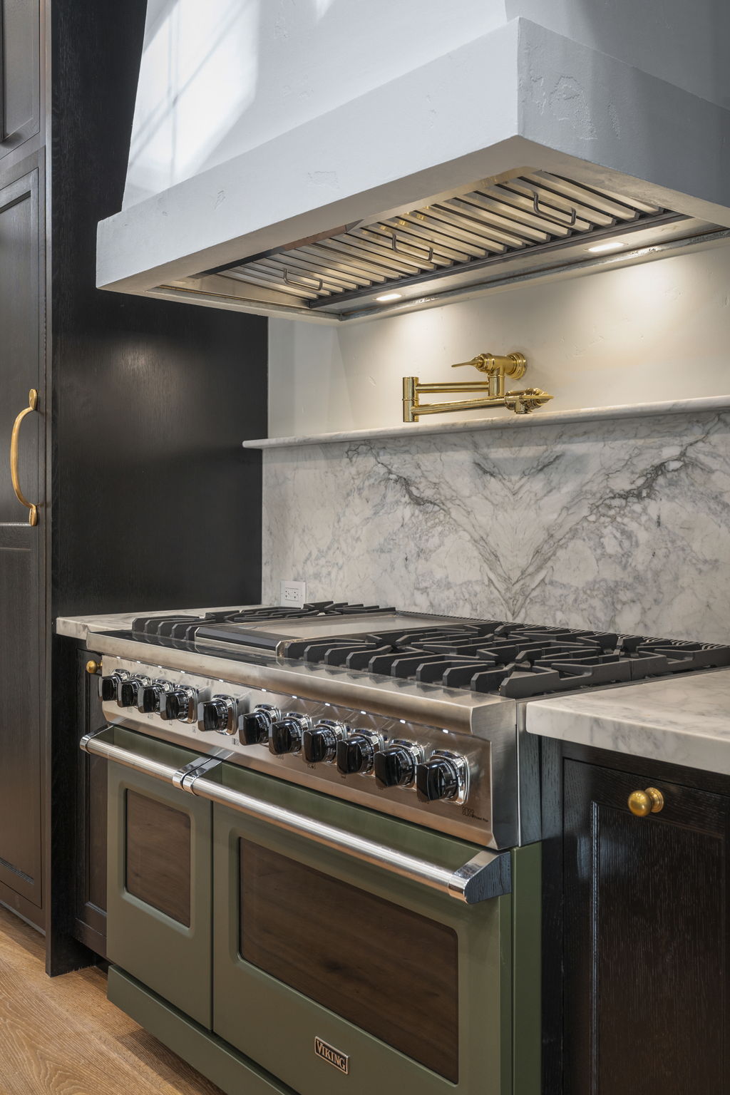 48-inch Viking range with brass pot-filler and honed marble backsplash