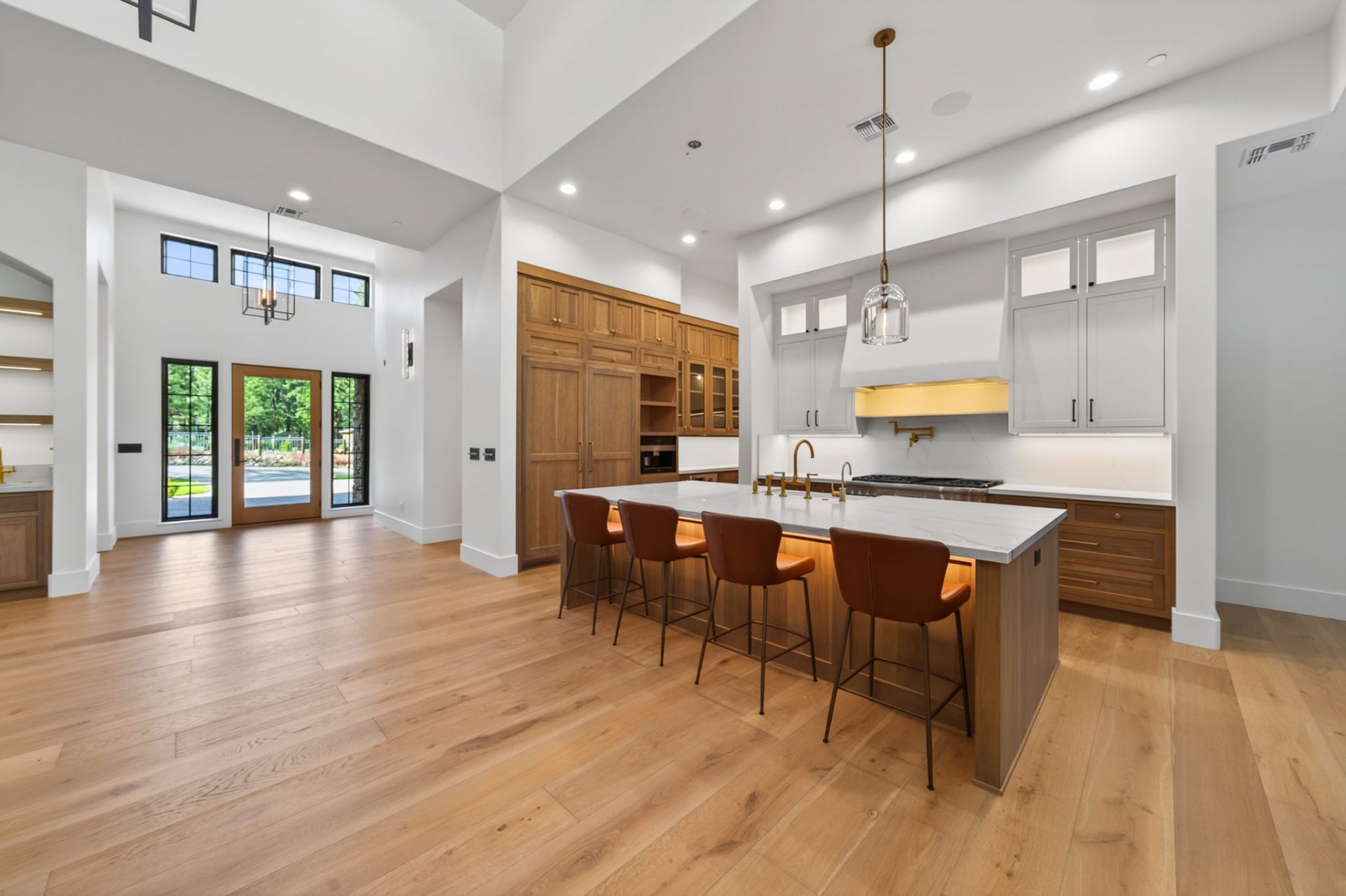 Chef's kitchen with reclaimed timber island and leather barstools