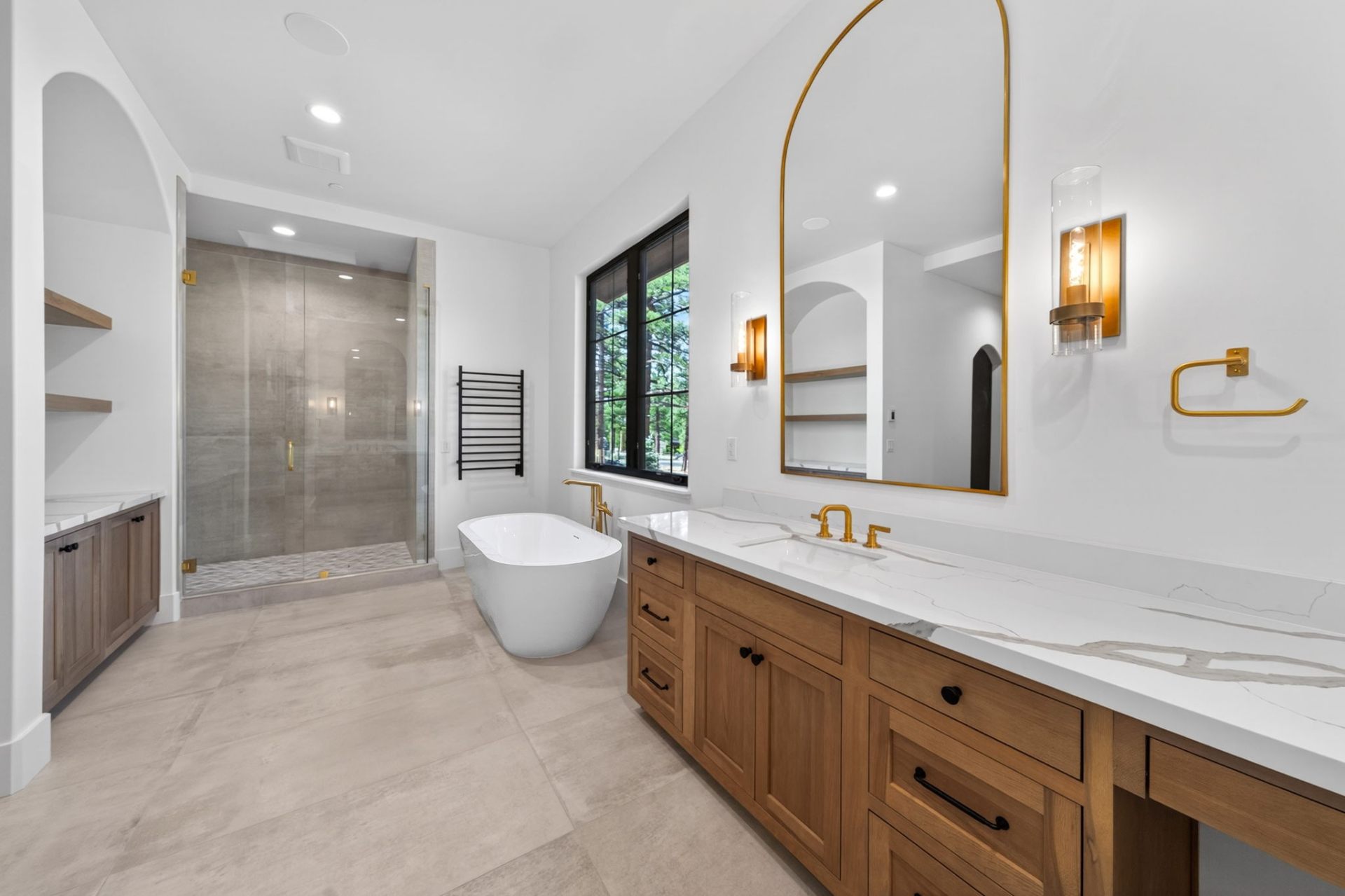 Primary bath with freestanding tub and antique brass fixtures