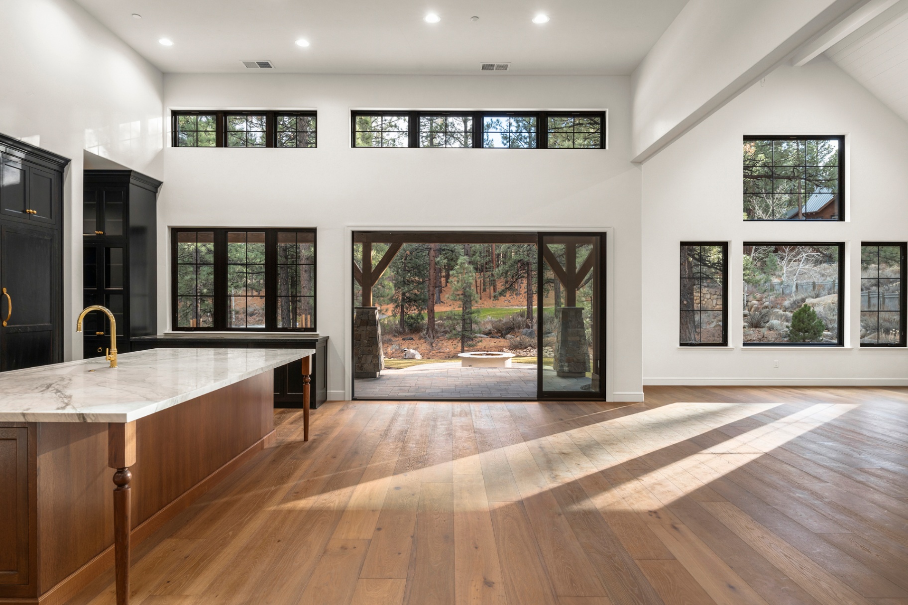 Great room with pocketing glass walls opening to the forest patio